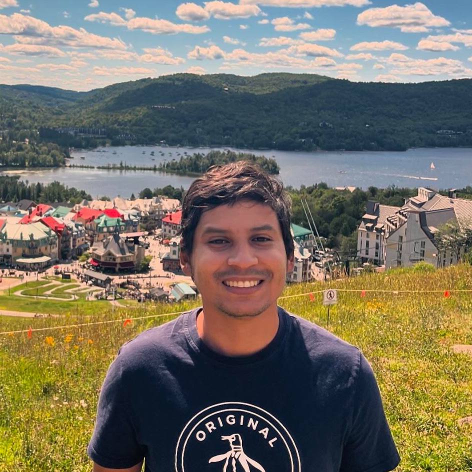 Daniel chilling in a field and looking pretty happy about it.