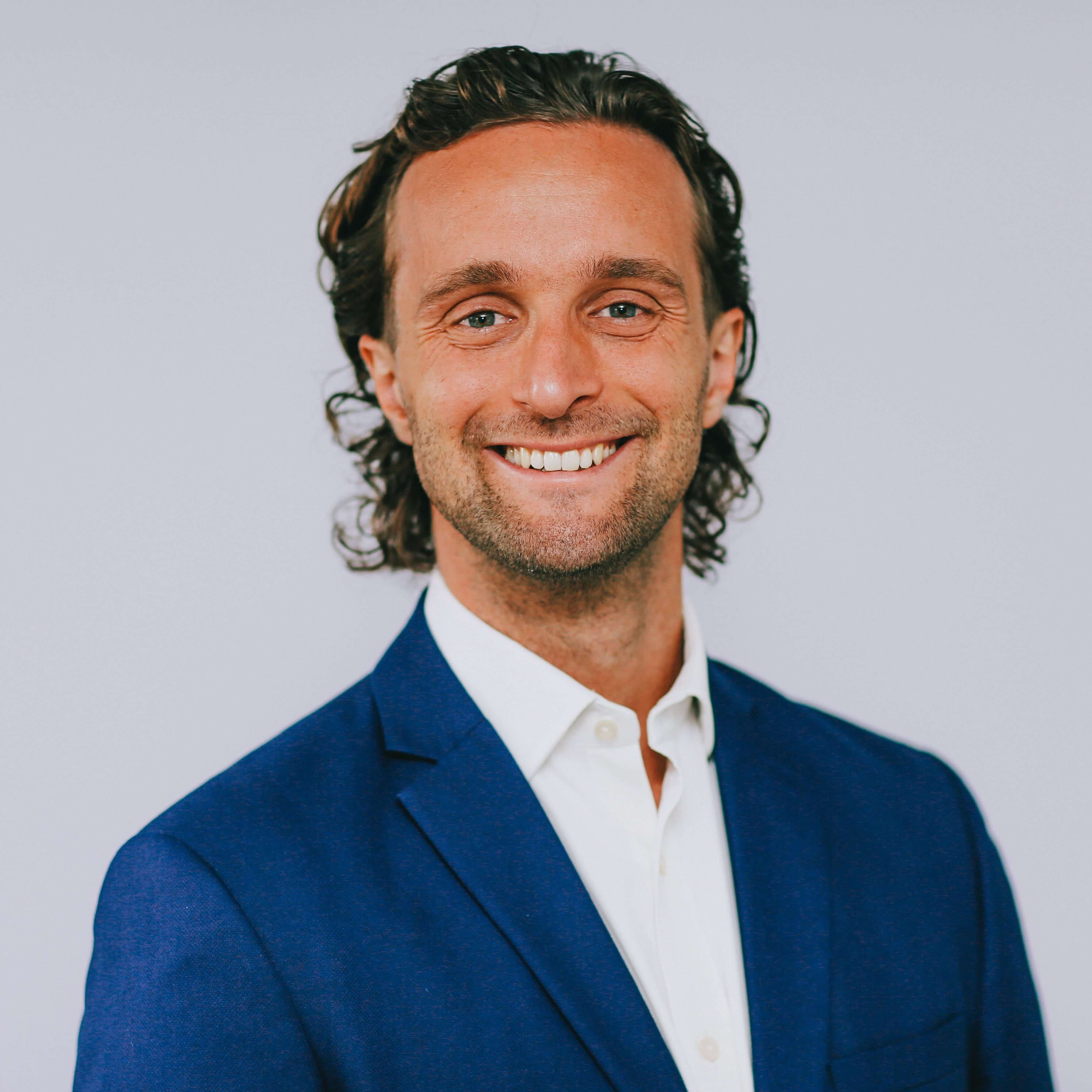 Liam Hartley headshot wearing a suit